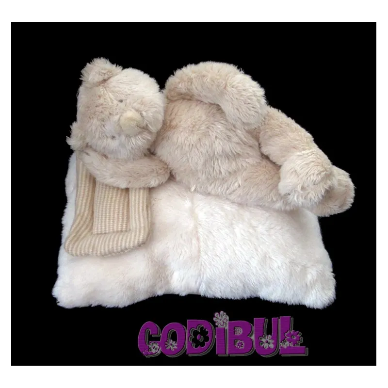 MOULIN ROTY Doudou musical ours allongé sur coussin linvosges