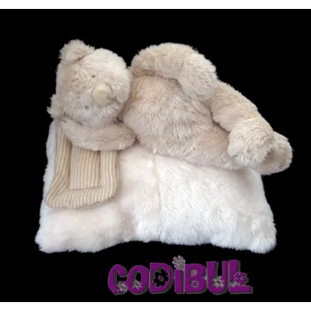 MOULIN ROTY Doudou musical ours allongé sur coussin linvosges